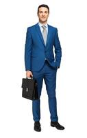 Full length of a handsome businessman holding a briefcase against white photo