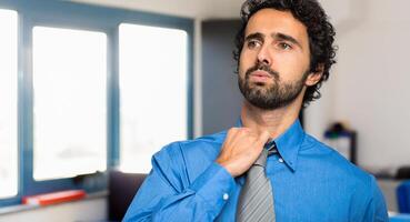Sweating businessman due to hot climate photo