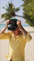 pilot of FPV drone puts on goggles for flight. Drone pilot in Maldives. vertical video