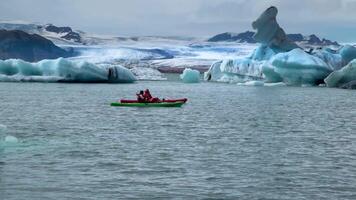 kayakistes bouge toi par une fusion glacier lagune à jökulsarlon, Islande. 4k video