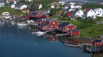 Fishing town of Reine on Lofoten islands in Norway, popular tourist destination on sunny summer day. 4K video