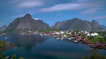 Fishing town of Reine on Lofoten islands in Norway, popular tourist destination on sunny summer day. 4K video