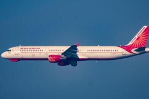 New Delhi, India, December 25 2023 - Air India Airbus A320 take off from Indra Gandhi International Airport Delhi, Air India domestic aeroplane flying in the blue sky during day time photo