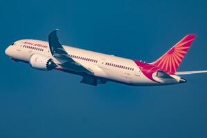 New Delhi, India, December 25 2023 - Air India Airbus A320 take off from Indra Gandhi International Airport Delhi, Air India domestic aeroplane flying in the blue sky during day time photo