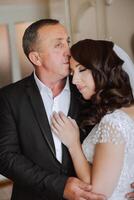 A beautiful bride with her father on her wedding day. The best moments of the wedding day. Daughter and father. photo