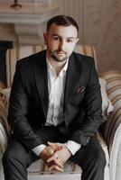 portrait of a handsome man in a hotel room in the morning. Preparation for an event or a new working day. New opportunities, acquaintances. Close-up portrait photo