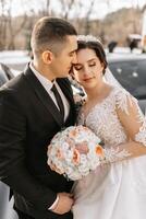 Wedding couple in love. A beautiful bride and an elegant groom tenderly embrace and enjoy the day. A stylish couple of newlyweds. Concept of marriage photo
