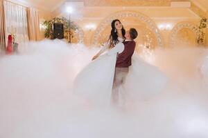 the wedding of the bride and groom in an elegant restaurant with great light and atmosphere. The first dance of the bride and groom. photo