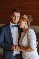 mother helps her adult son prepare for the wedding ceremony. An emotional and touching moment at a wedding. A mother hugs her son photo