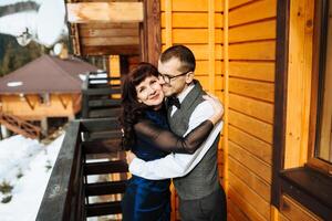 mother helps her adult son prepare for the wedding ceremony. An emotional and touching moment at a wedding. A mother hugs her son photo