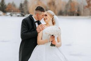 Cropped wedding portrait of the groom. The bride fixes the groom's bow tie. A man in a black suit. Winter wedding photo