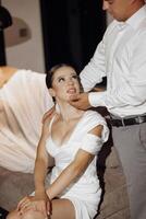 portrait of the bride and groom in the hotel. The groom gently touches the bride. After the wedding ceremony photo