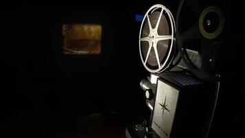 Turning on apparatusFilm negative tap showing film in cinema projection light video