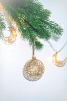 Golden Christmas ball on Christmas tree, creative photo, new year, christmas photo