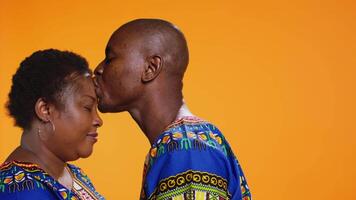 Caring man giving a kiss on his girlfriend forehead, presenting his love and affection for her. Romantic boyfriend kissing his partner, showing sincere deep feelings on camera. Close up. video