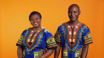 African american couple showing thumbs up symbol on camera, feeling positive and presenting their satisfaction. Married people expressing approval and giving like sign in studio. video