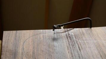 Luthier cutting with a saw and shapes the wood to manufacture a new guitar video