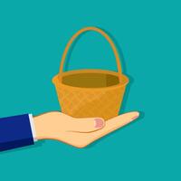 Hand holding an empty wicker basket vector