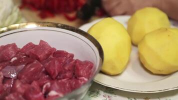 Hands of an elderly woman cutting peppers on a cutting board. video