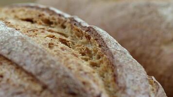 Camera is zoom through sliced and whole wheat bread and wheat ears to the clay pots video