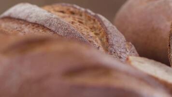 Camera is zoom through sliced and whole wheat bread and wheat ears to the clay pots video