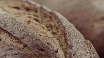 Camera is zoom through sliced and whole wheat bread and wheat ears to the clay pots video