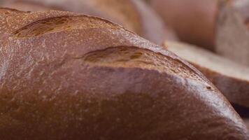 Camera is zoom through sliced and whole wheat bread and wheat ears to the clay pots video