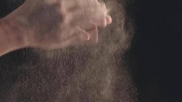 Close-up of male hands shaking off flour video