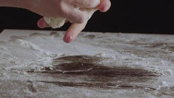 Male hands divide baking dough into shares on a board sprinkled with flour video