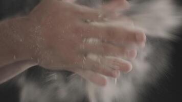 Close-up of male hands shaking off flour video