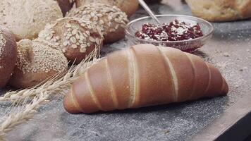 Close-up of different types of fresh baked Dutch bread is on the wooden table video