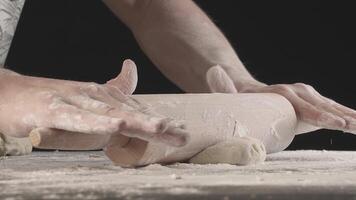 Hands roll out baking dough using rolling pin video