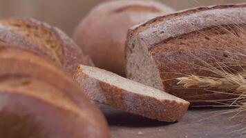 Camera is zoom through sliced and whole wheat bread and wheat ears to the clay pots video