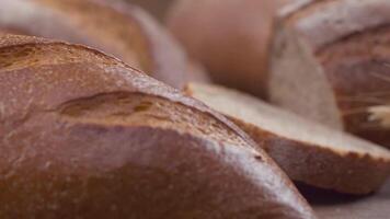 Camera is zoom through sliced and whole wheat bread and wheat ears to the clay pots video