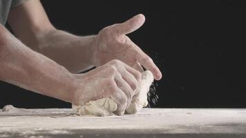Male hands divide baking dough into shares on a board sprinkled with flour video