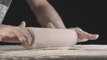 Hands roll out baking dough using rolling pin video