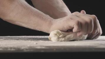 Male hands divide baking dough into shares on a board sprinkled with flour video