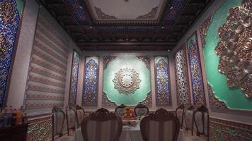 Dining room with richly colored walls and ceiling with Arabic-oriental patterns and rosettes video