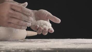 Hands roll out baking dough using rolling pin video