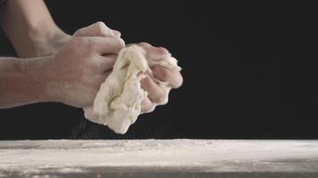 Male hands divide baking dough into shares on a board sprinkled with flour video