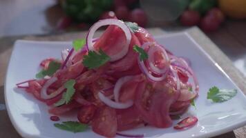 Close-up of fresh salad made of red cabbige, tomatoes, onions, basil, arugula and pieces of fried meat video