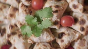 Close-up of rotating dish with samsa Central Asian buns decorated with parsley video