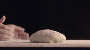 Male hands sprinkle a piece of baking dough with flour video