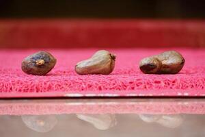 Close Up of Cashew Nuts Placed on The Matte photo