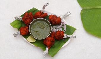 Chicken Lollipop Plate Served in Banana Leaf, Indian Cuisine Chicken Lollipop, Nonveg Food Chicken Lollipop photo