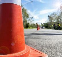 Orange warning traffic cones set up in the middle of the road. For safety in driving photo