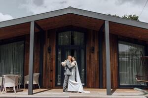 A young newlywed couple. Happy bride and groom hug and kiss after the ceremony photo