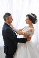 A beautiful bride with her father on her wedding day. The best moments of the wedding day. Daughter and father. photo