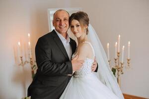 A beautiful bride with her father on her wedding day. The best moments of the wedding day. Daughter and father. photo