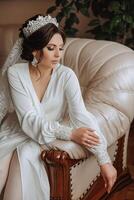 A beautiful brunette bride with a tiara in her hair is getting ready for the wedding in a beautiful robe in boudoir style. Close-up wedding portrait, photo. photo